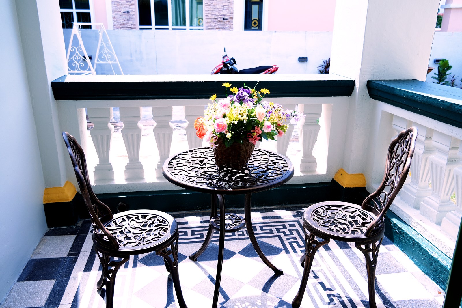 A small balcony table and chairs, a quiet corner to work or relax