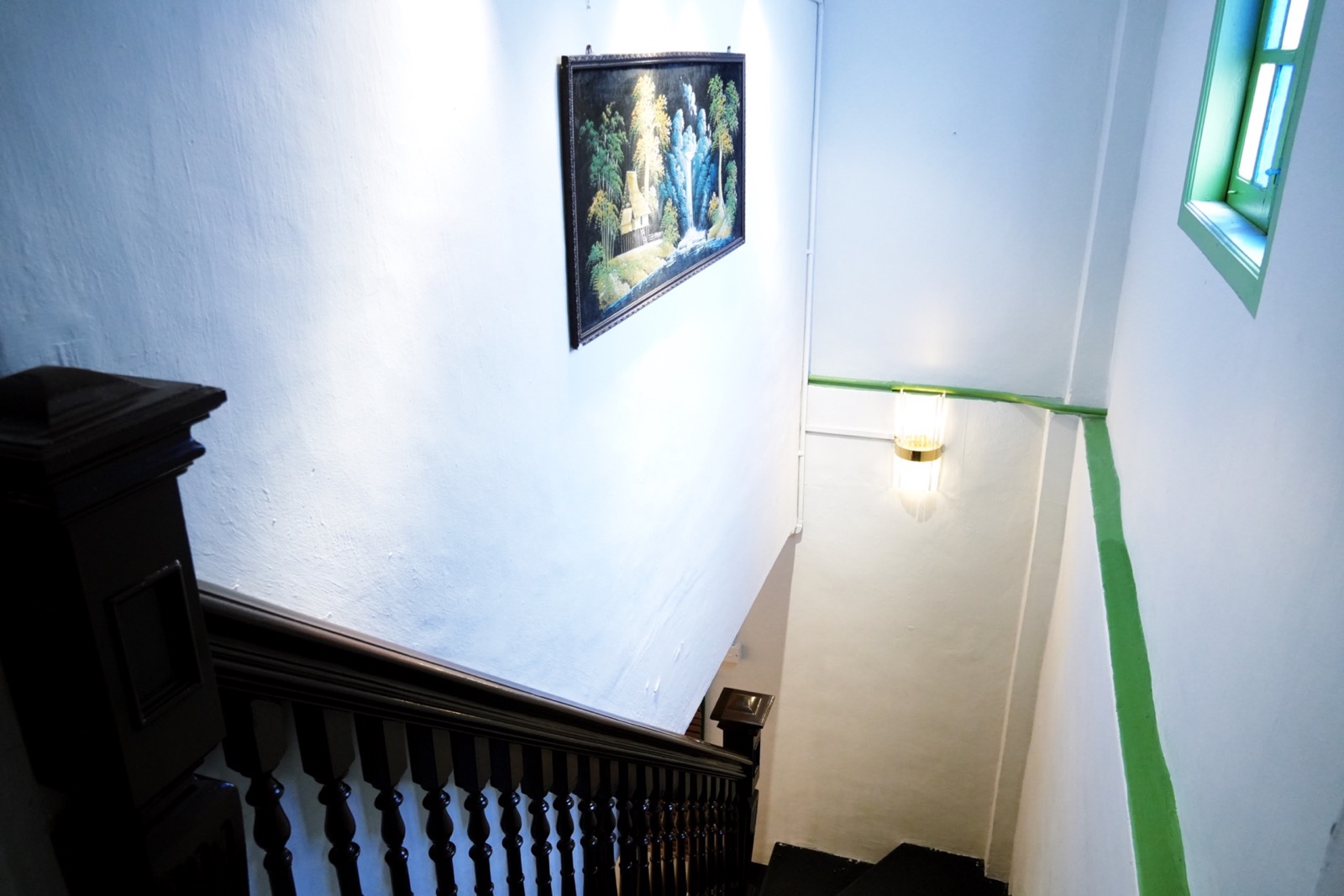 Original dark-timber staircase inside Arvena Living